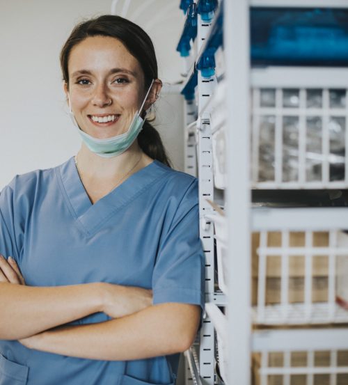 Happy nurse in a medical supplies room
